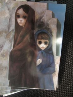 two dolls are standing next to each other