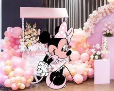 a minnie mouse party with balloons and decorations