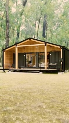 a small cabin in the middle of a field with trees behind it and grass on the ground