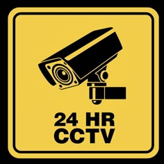 a black and yellow sign with the words 24 hr cctv on it's side