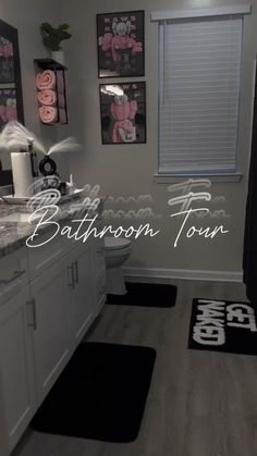 a bathroom with black and white rugs on the floor