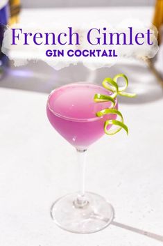 a pink cocktail sitting on top of a table