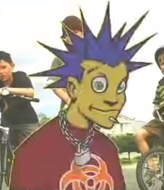 two young men riding bikes next to each other on a street with an image of a cartoon character in the background