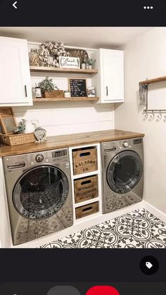 a washer and dryer sitting in a room next to each other on top of cabinets