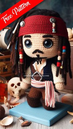 a crocheted pirate doll sitting on top of a table