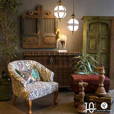 a living room filled with lots of furniture next to a tall wooden cabinet and potted plant