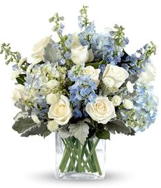 a vase filled with white and blue flowers