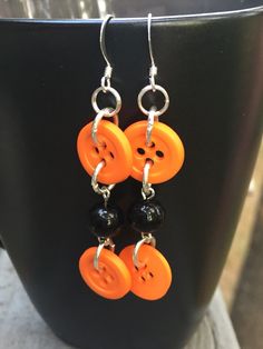 Orange buttons make quite a statement on these one of a kind earrings. The black beads give them a kind of Halloween look. I love the combination of colors, a great pair for the autumn season. These button earrings can also be a celebration of the University of Tennessee. These earrings hang around 2 inches on silver plated french hooks. Check out these beauties.... https://www.etsy.com/listing/217978155/on-fire-beaded-dangle-earrings-bead?ref=shop_home_active_19 Handmade Spooky Black Earrings, Handmade Black Halloween Earrings, Unique Handmade Black Plug Earrings, Nickel-free Black Spooky Earrings, Unique Black Dangle Plug Earrings, Unique Black Plug Earrings With Ear Wire, Unique Black Nickel-free Plug Earrings, Edgy Handmade Earrings For Halloween, Edgy Handmade Halloween Earrings