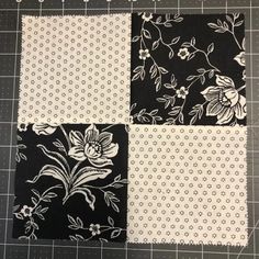 four squares with black and white flowers on them, one has been cut in half