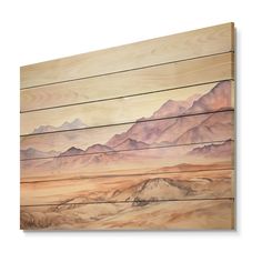 a wooden wall hanging on the side of a building with mountains painted on it's sides