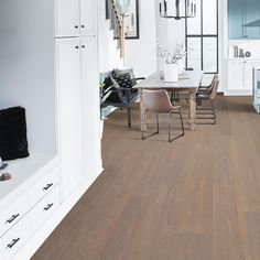 a dining room with wood floors and white walls