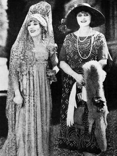 an old photo of two women in dresses and hats