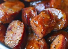 cooked sausages are in a pan with brown sauce