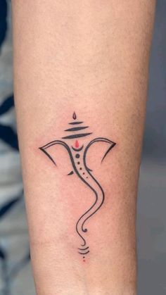 a woman's leg with a tattoo on it that has an image of the hindu god