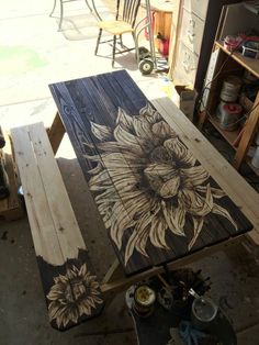 a wooden table with sunflowers painted on it