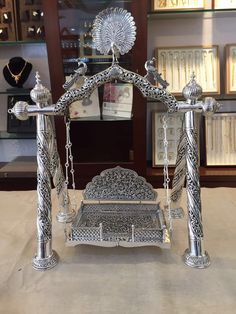 an ornate silver swing on display in a store