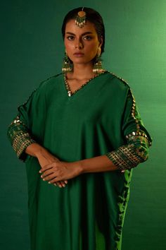 Emerald green placement sequin mirror hand embroidered kurta with batwing sleeves. Paired with a slim fit pant.
Components: 2
Pattern: Hand Embroidery
Type Of Work: Sequins
Neckline: V Neck
Sleeve Type: Full Sleeves
Fabric: Satin
Color: Green
Other Details: 
Note: All the jewellery worn by the model is not for sale
Occasion: Sangeet - Aza Fashions Kurta Pant Set, Satin Hands, Pant For Women, Sequin Patch, Indian Wedding Wear, Satin Color, Kurta With Pants, Green Satin, Slim Fit Pants