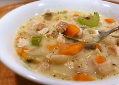 a white bowl filled with chicken and vegetable soup