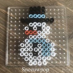 a plastic tray with some black and white beads on it