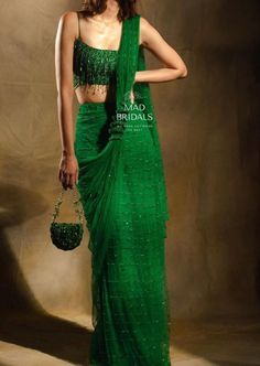 Elevate your style with our exquisite handcrafted emerald green saree--a masterpiece in pure premium net. Impeccably adorned with pearls and intricate hand embellishments, this ensemble exudes timeless elegance. Picture yourself in a perfectly tailored blouse, crafted to your measurements, paired seamlessly with a pre-stitched saree for effortless draping. Unveiling the Details: Color: Emerald Green Craftsmanship: Masterful Handwork Fabric: Luxurious Pure Premium Net **Important Notes All our items are meticulously handmade and uniquely tailored for our valued customers. Expect minor variations in the actual product compared to the displayed image. Product color may slightly vary due to photographic lighting sources or your monitor settings. Please be advised that once an order is placed, Red Saree Bridal, Cocktail Saree, Handmade Saree, Saree Red, Drape Sarees, Indian Fashion Trends, Saree Designer, Fancy Sarees Party Wear, Indian Designer Sarees