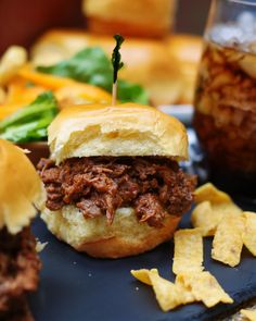 a close up of a sandwich on a plate with chips