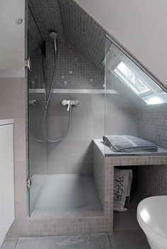 a bathroom with a sink, toilet and shower in it's corner stall next to the bathtub