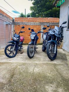 two motorcycles parked next to each other in front of a building