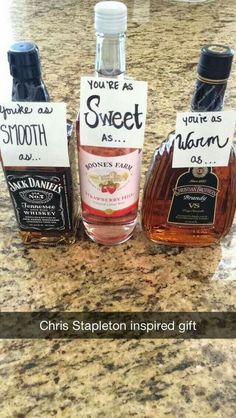 three bottles of liquor sitting on top of a counter