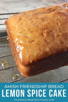 a loaf of lemon spice cake sitting on top of a cooling rack with the words, amish friendship bread lemon spice cake