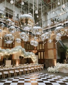 a large room with chandeliers hanging from the ceiling and tables set up for an event