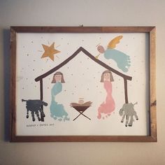 a nativity scene is displayed in a wooden frame