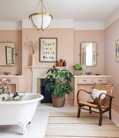 a bath room with a tub a chair and a fire place