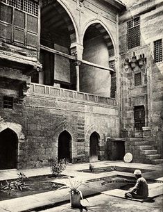 an old black and white photo of a courtyard