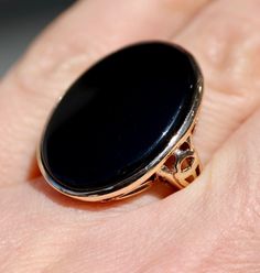 Metal: solid 10K 10Kt yellow gold   Marks/Stamps: "10K" inside      Size: about 7.75   Natural Black Onyx: about 24 mm x 18 mm as setting permits  Setting: about 1" along a finger     Weight: 6.49 grams   Condition: Great Vintage, as pictured Black Cabochon Signet Ring For Formal Occasions, Formal Black Cabochon Signet Ring, Black Cabochon Ring In 14k Gold, Black Cabochon 14k Gold Rings, Black 14k Gold Cabochon Ring, 14k Gold Black Cabochon Rings, Black Victorian Rings With Polished Finish, Victorian Black Rings With Polished Finish, Victorian Style Black Rings With Polished Finish