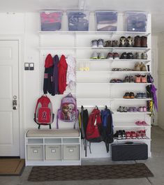 an organized closet with shoes, backpacks and other items on the shelves in front of a refrigerator