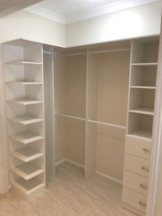 an empty walk in closet with shelves and drawers