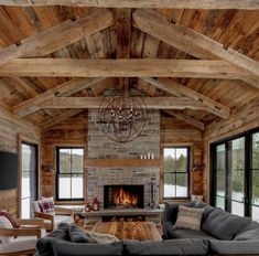 a living room filled with furniture and a fire place in the middle of a room