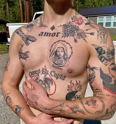 a man with many tattoos on his chest