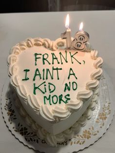 a heart shaped cake with candles on it that says frank, i ain'a kid and no more