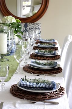 the table is set with plates and place settings