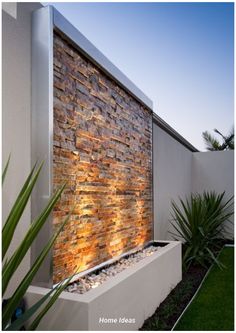 an outdoor water feature with plants and grass