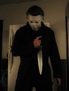 a man in a creepy mask holding a knife