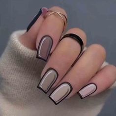 a woman's hands with black and white manies on their nails, one is holding