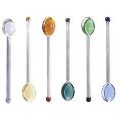 six spoons lined up in different colors and sizes, each with an upside down spoon