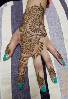 a woman's hand with henna tattoos on it