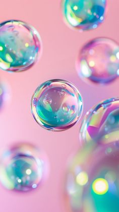 soap bubbles floating in the air on a pink background