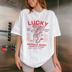 Rock some retro vibes with our Lucky Tiger Shirt! This garment-dyed t-shirt features a cool vintage graphic for a Chinese restaurant called "Lucky Tiger" complete with a bold tiger image in the center. Perfect for Gen Z streetwear lovers, this trendy tee adds a unique twist to your wardrobe. Whether you're a fan of Chinese food or just love standout graphics, this shirt is a must-have. Snag yours now and level up your style game with this epic piece! Fit: Available in unisex sizes S-4XL. This t- Lucky Tiger, Tiger Images, Asian Streetwear, Graphic Streetwear, Tiger Shirt, Aesthetic Shirt, Retro Graphic Tees, Streetwear Tops, Aesthetic Shirts