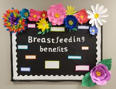 a bulletin board with paper flowers and writing on it that says breastfeeding benefits