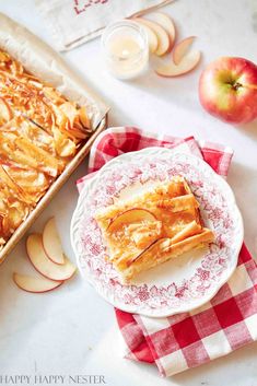 an apple pie on a plate next to some apples