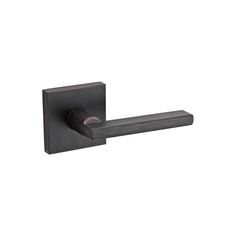 the door handle is made out of metal and has a square shape with an iron finish